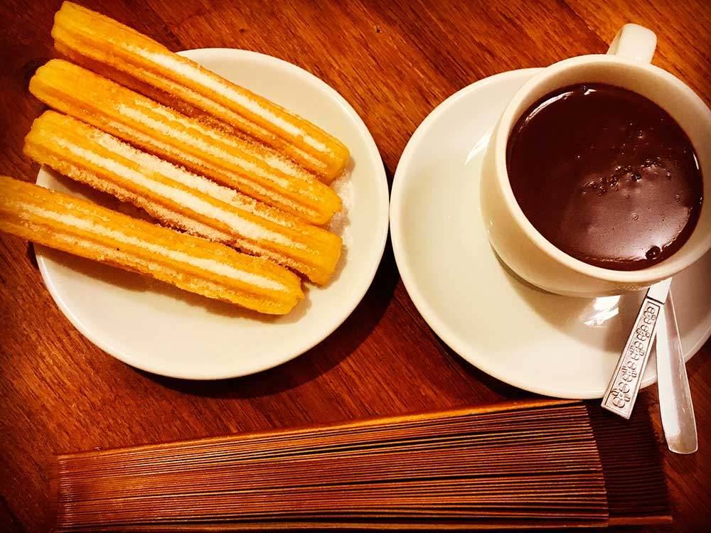 Eating churros with chocolates